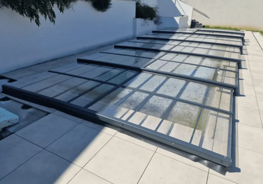 Sehr flache Poolüberdachung aus transparenten Elementen auf einer Terrasse